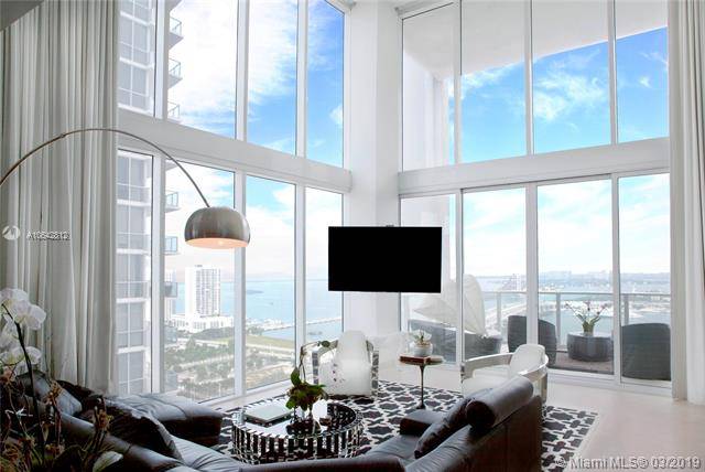 Amazing bay & city views from this 2 story corner loft with 20' ceilings
