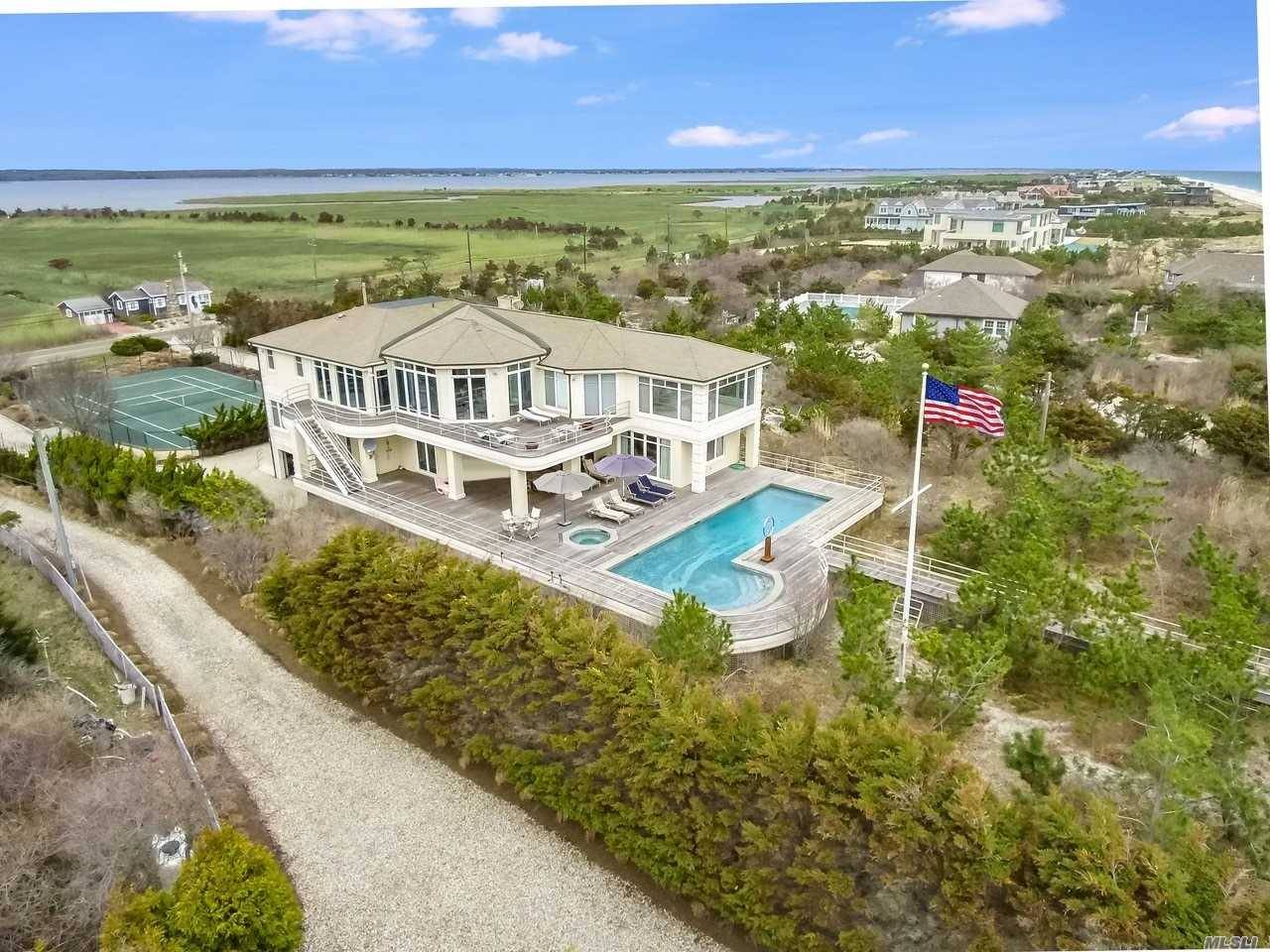 This 5 bedroom, 7 bath retreat is poised along 100 ft.