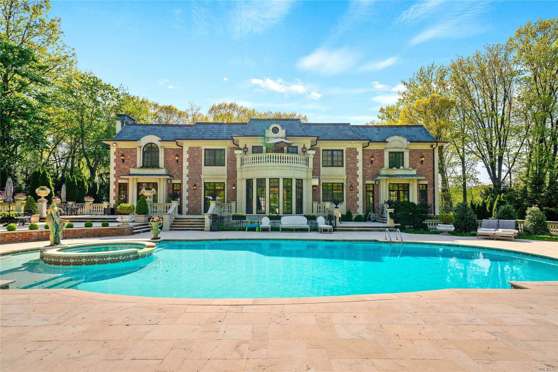 Custom built brick and stone center hall colonial situated an acre of flat property in the prestigious Village of Kings Point.