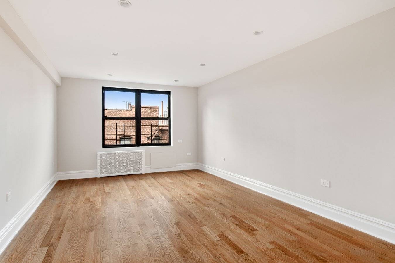 Modern, gut renovated one bedroom, one bath apartment featuring new oak hardwood floors, a large living room, separate kitchen with Quartz counter tops, abundant cabinet space, stainless steel appliances and ...