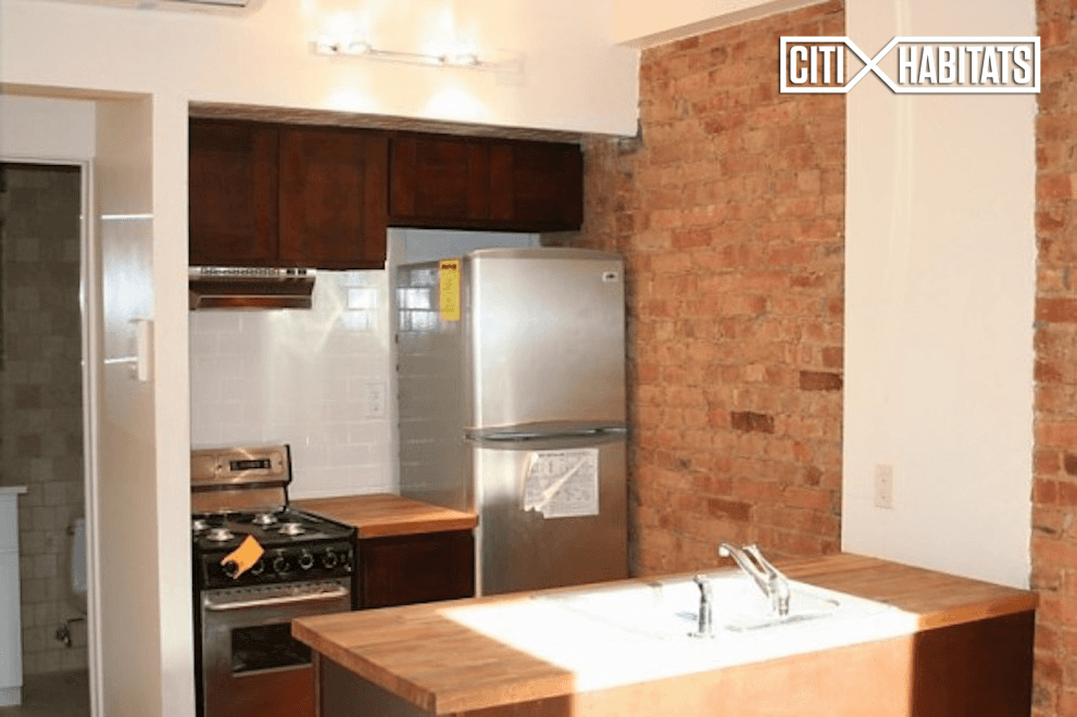 Classic New York studio features hard wood floors, stainless steel appliances, exposed brick and beautiful bathroom tiling.