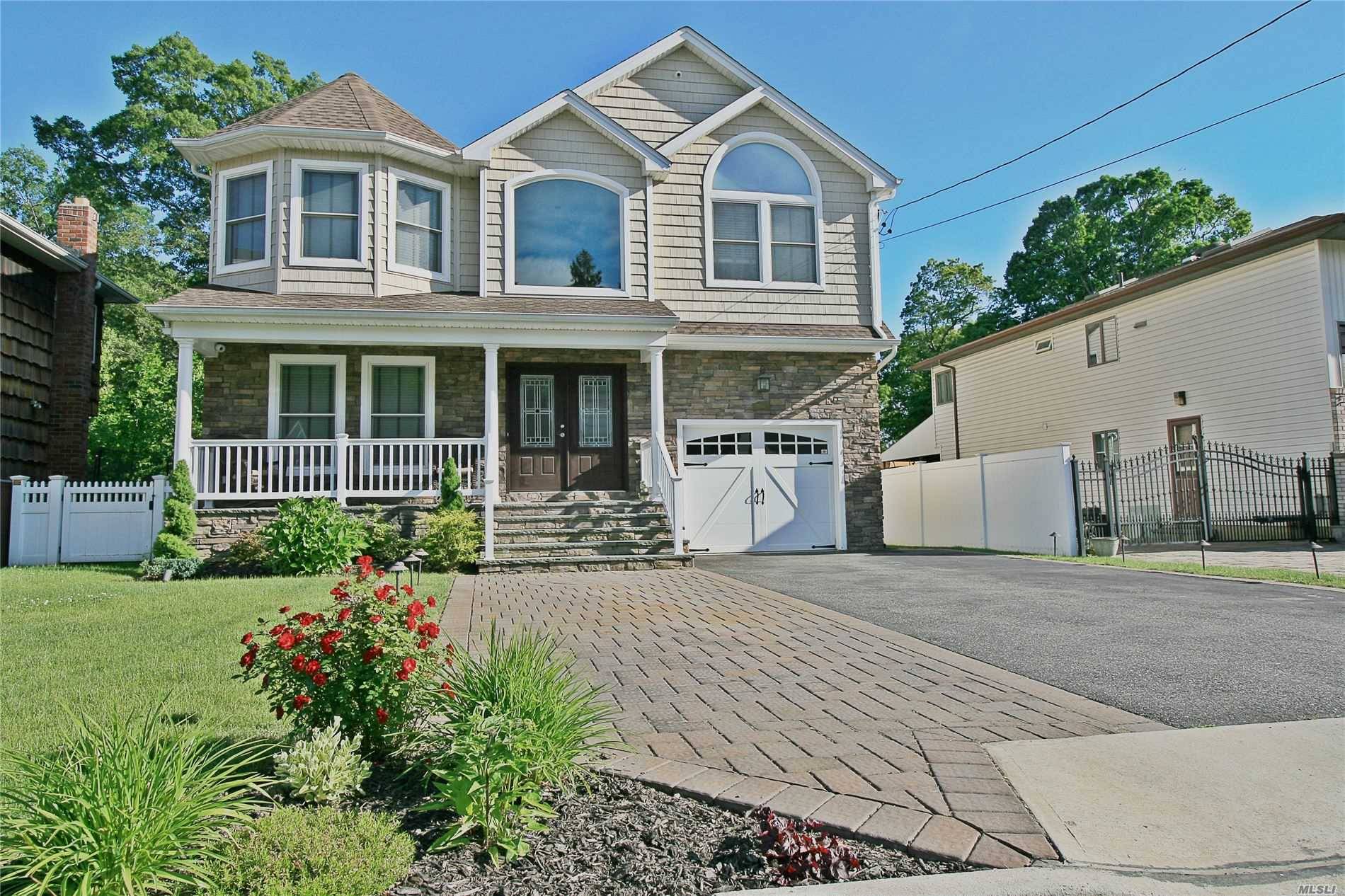 Nestled in the Twin Lakes enclave of Wantagh, this elegant stoic colonial built in 2013 sits on a fully fenced 240' deep lot !