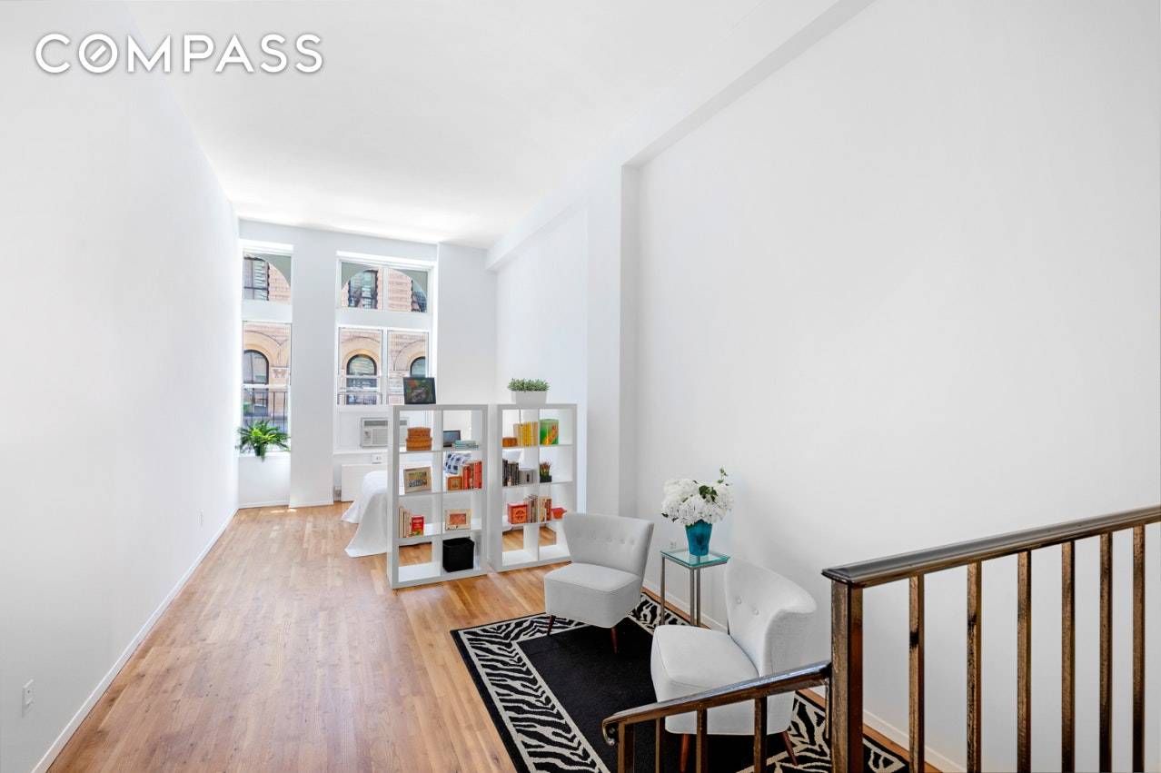 OPEN HOUSE CANCELLED Spacious loft studio with 12'8 ceilings, three huge windows, sunny southern exposure, drop down living area and hardwood floors.