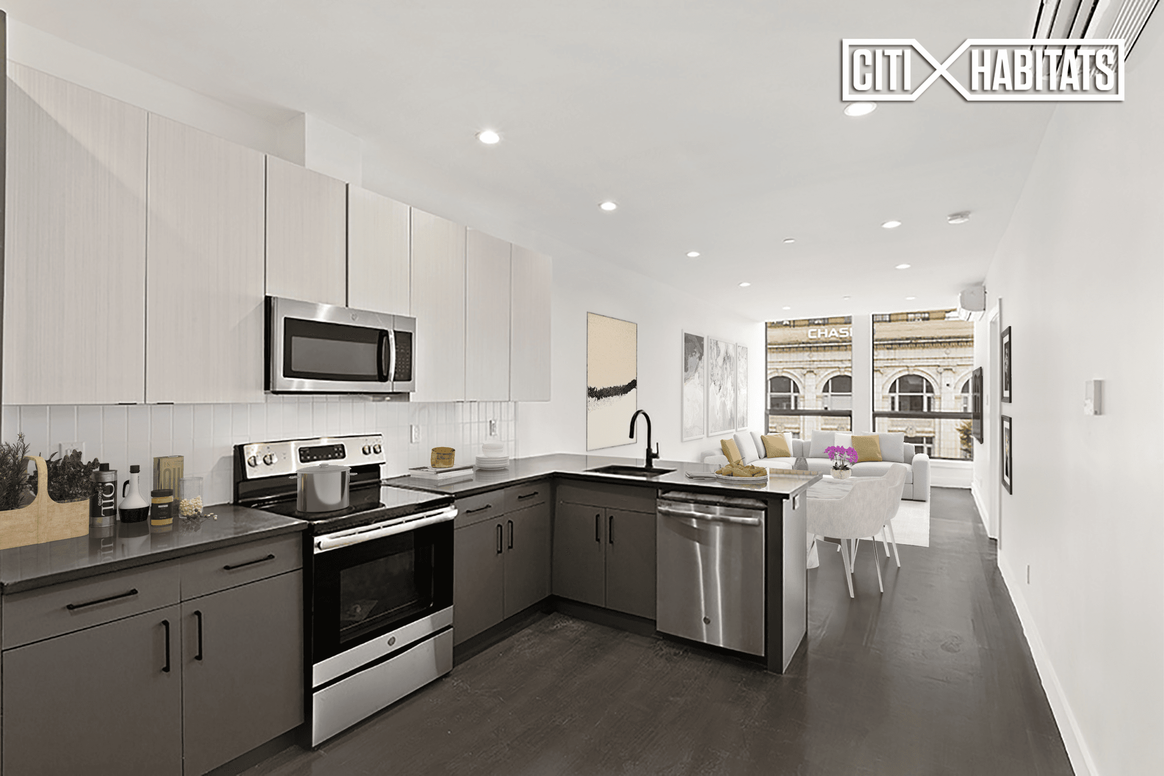 Spacious one bedroom loft with a kitchen island, washer dryer and oversized windows.