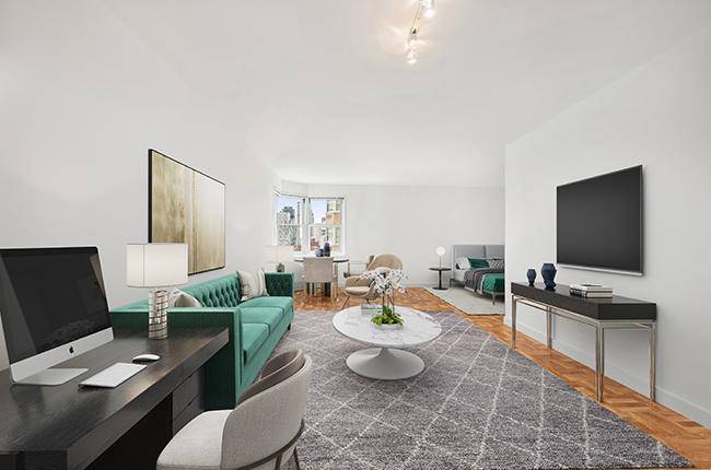 THIS SLEEPING ALCOVE STUDIO HAS A GRANITE KITCHEN WITH CUSTOM WHITE CABINETS AND STAINLESS STEEL APPLIANCES.
