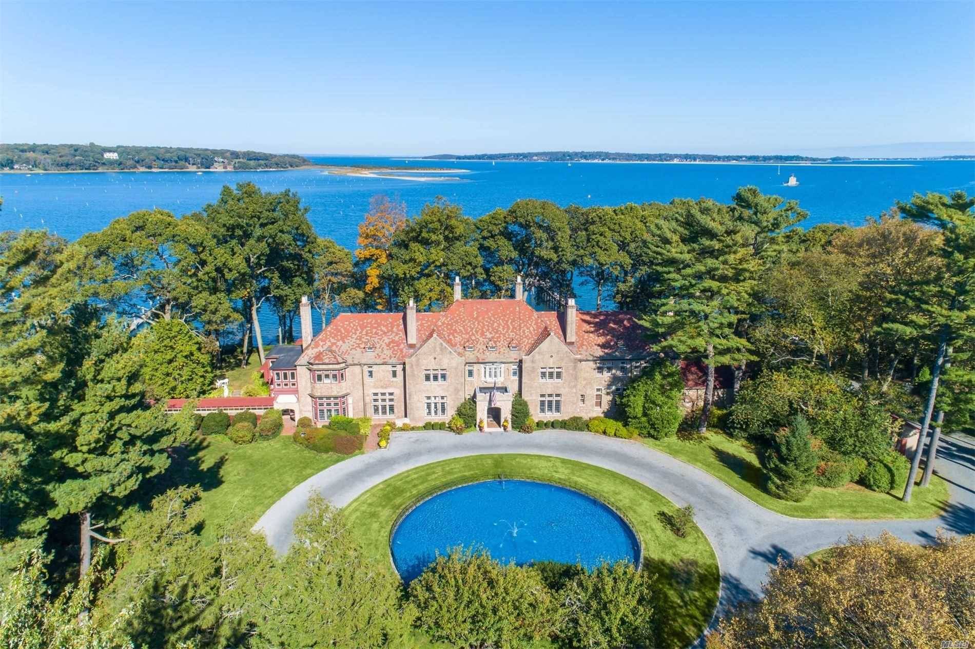 This historic water front estate is perfectly situated on 5 lush acres overlooking Lloyd Harbor.