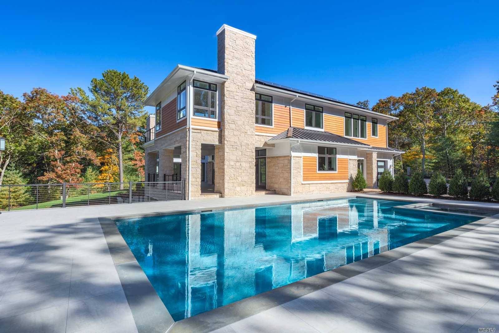 Along this long private driveway you'll come across this incredible newly built 7, 600 Sq.