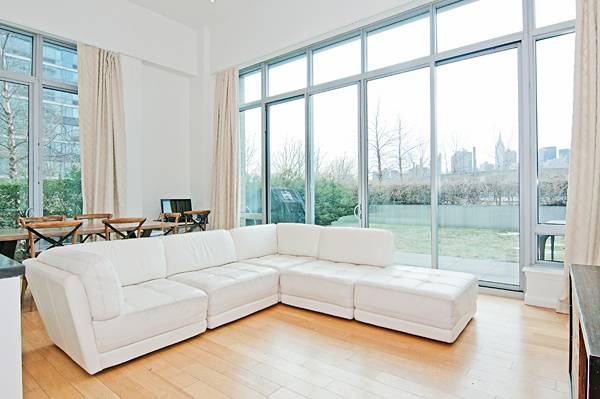 One of the largest 3 beds/3 baths in the building with 17 ft ceilings, a private garden and spectacular water-front/city views