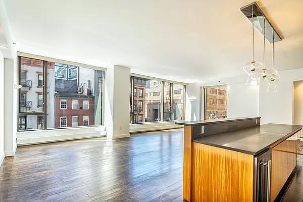 bright corner 3 Bedroom, 3.5 bathroom loft located in a premier full service building in West Soho.