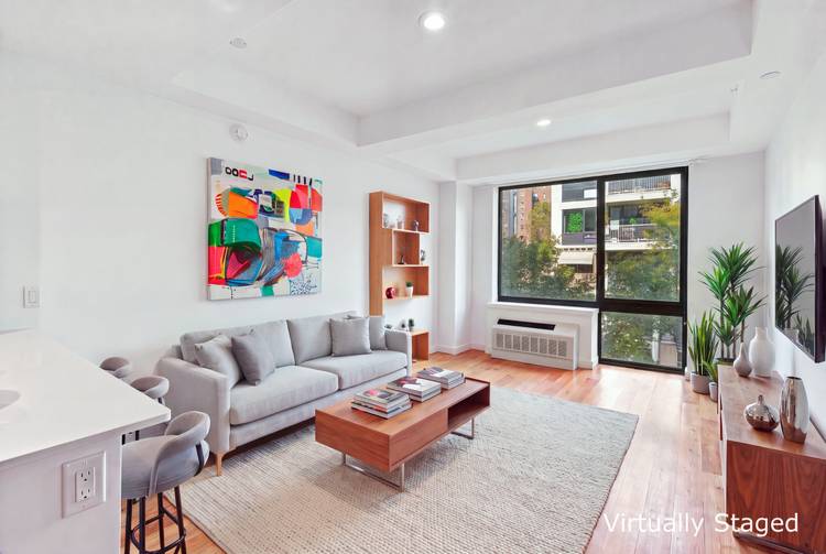 Bright and sunny, spacious one bedroom condo with a private terrace and a washer and dryer available in Harlem between Madison and Park Avenues