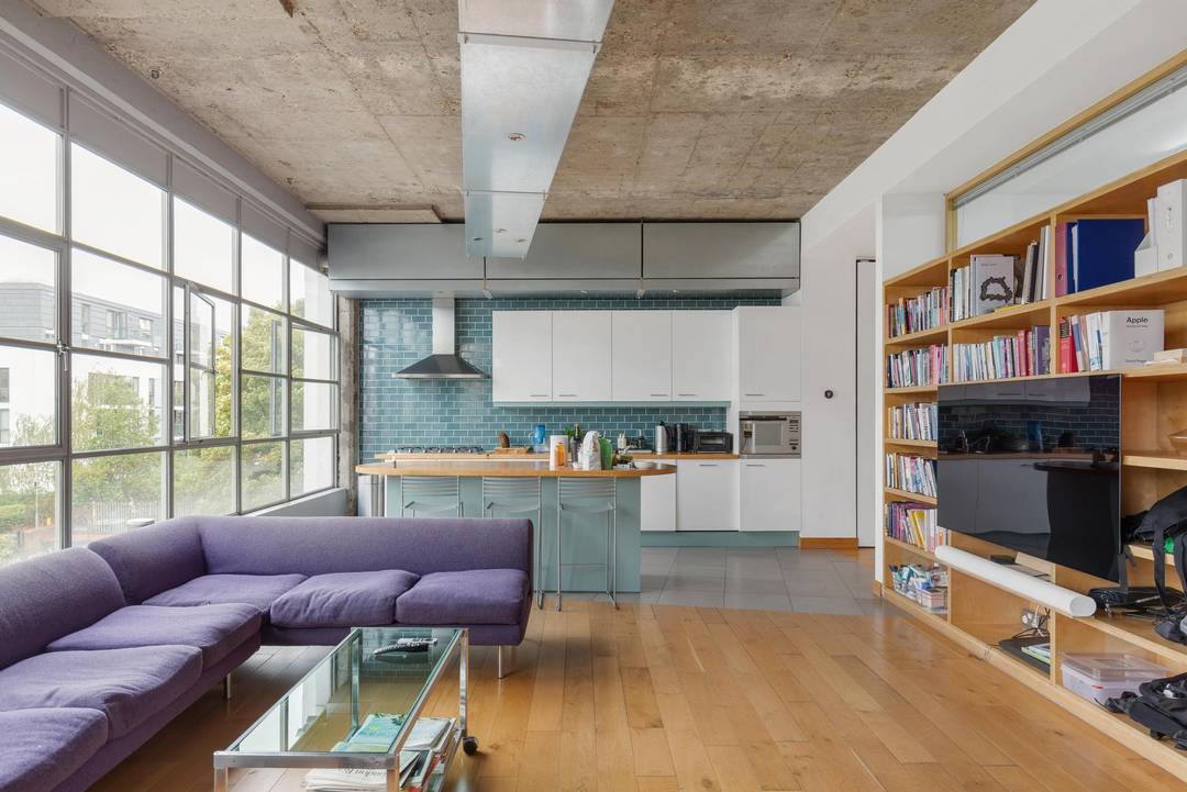 A SPECTACULAR 2-bed Loft with Balcony facing directly over the Regents Canal. High Ceilings, large Windows, Porter, Parking in a fully gated building.