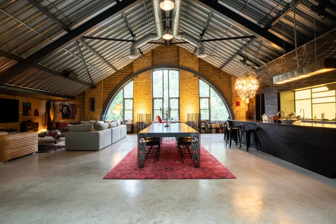 A Cathedral of Light and Steel Rising Above the Trees in a Historic London Warehouse