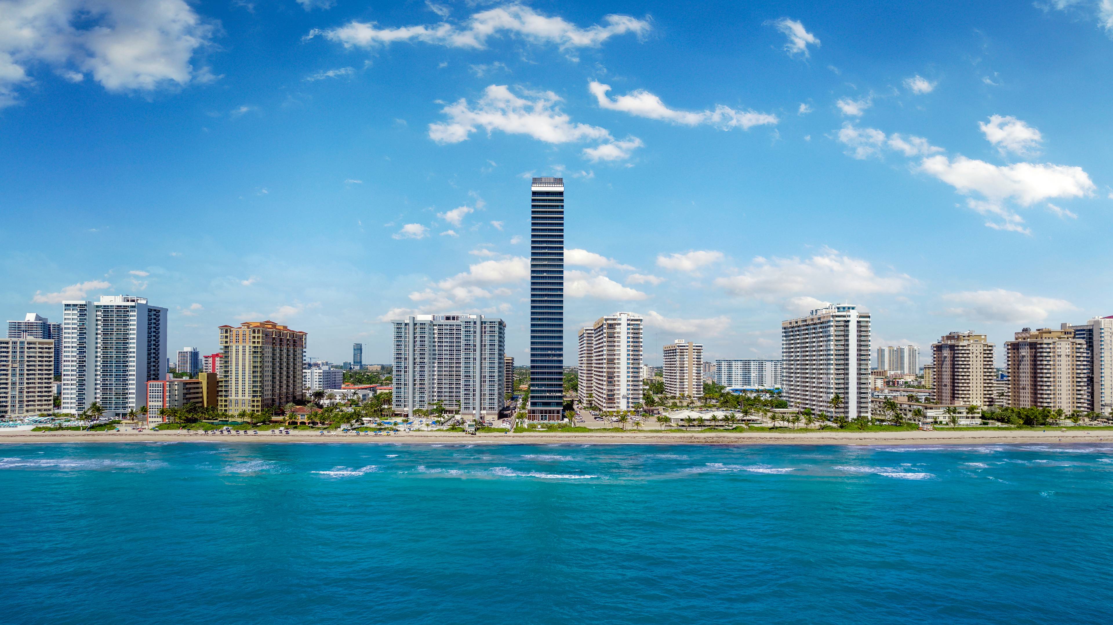 Golden Beach Miami: 38-story glass tower bathed in sunlight from sunrise to sunset