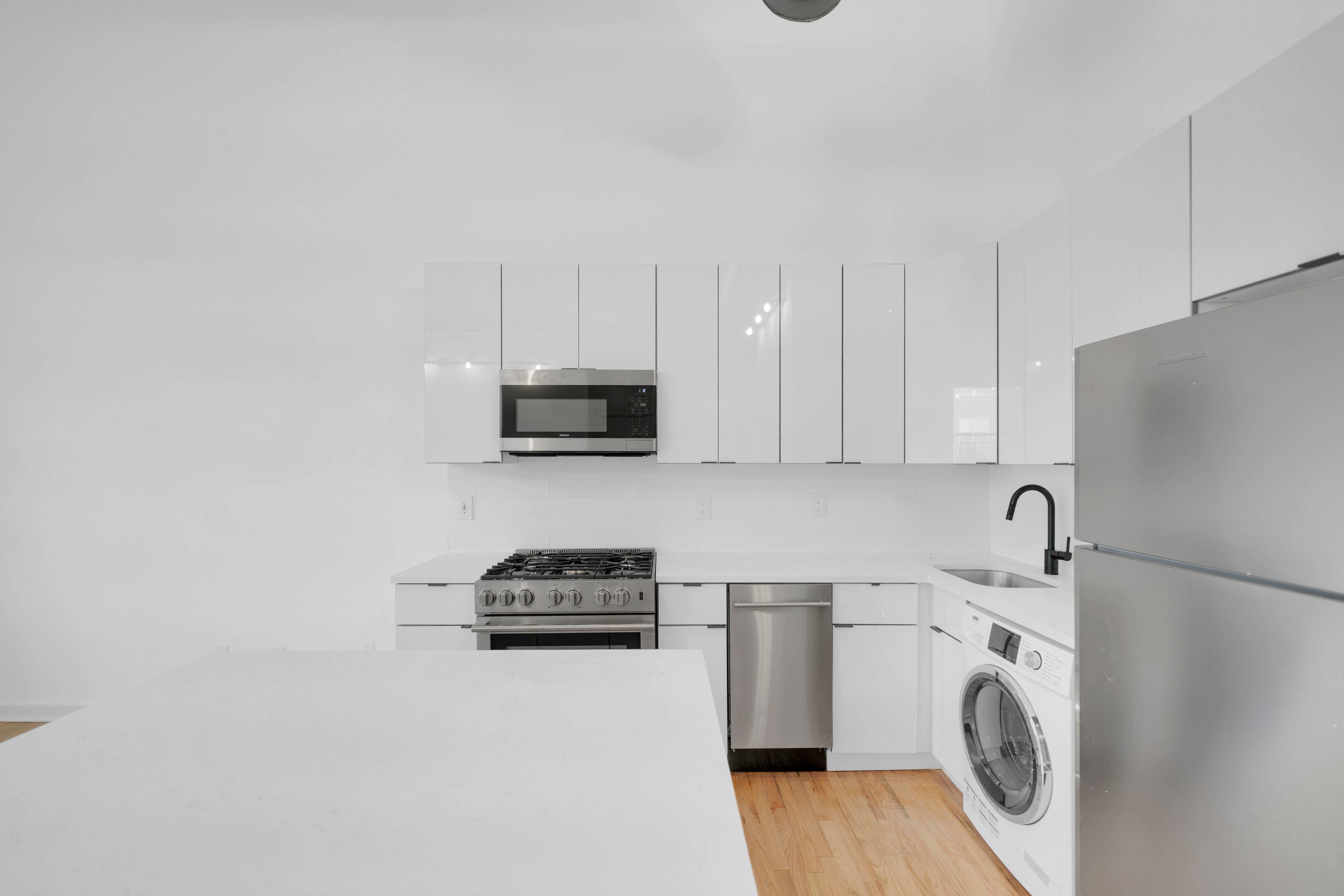 Rarely Available FULLY RENOVATED 1 Bedroom Loft Apartment with Soaring 20' Ceilings!  Laundry in the Unit and Building, On Site Parking!  Pets welcome!