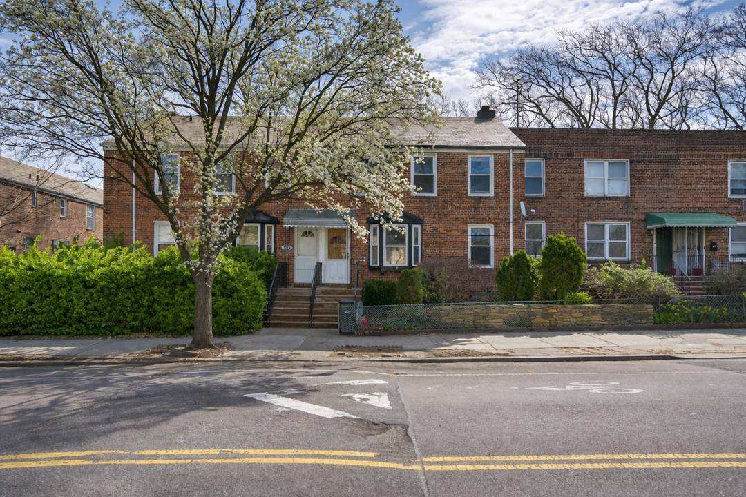 Charming three-level, 5-bedroom, 3-bath brick townhouse located in the highly sought-after Historic Sunnyside Gardens neighborhood