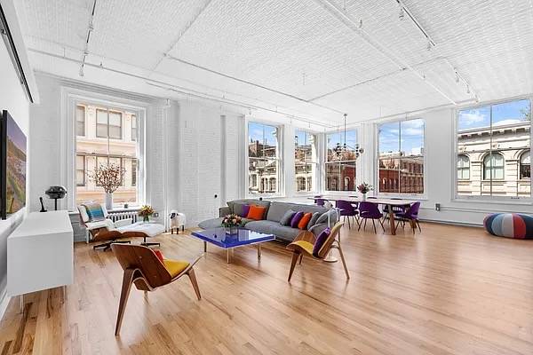 This sprawling corner 2,871 s/f loft, configured as a 3 BR / 2.5 BA home, features soaring 13’ ceilings and is flooded with day long natural light.
