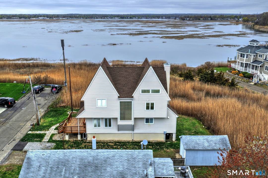 Experience coastal living at its finest in this custom, sun filled warm home offering breathtaking sunset views over the Housatonic River tidal marsh.