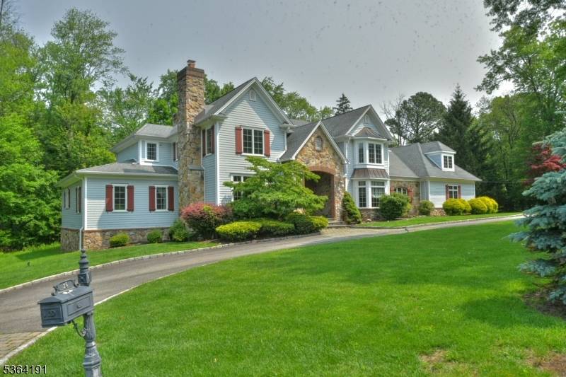 GRAND ELEGANT describes this stately colonial home that sits in a peaceful setting in a neighborhood of prominent properties.
