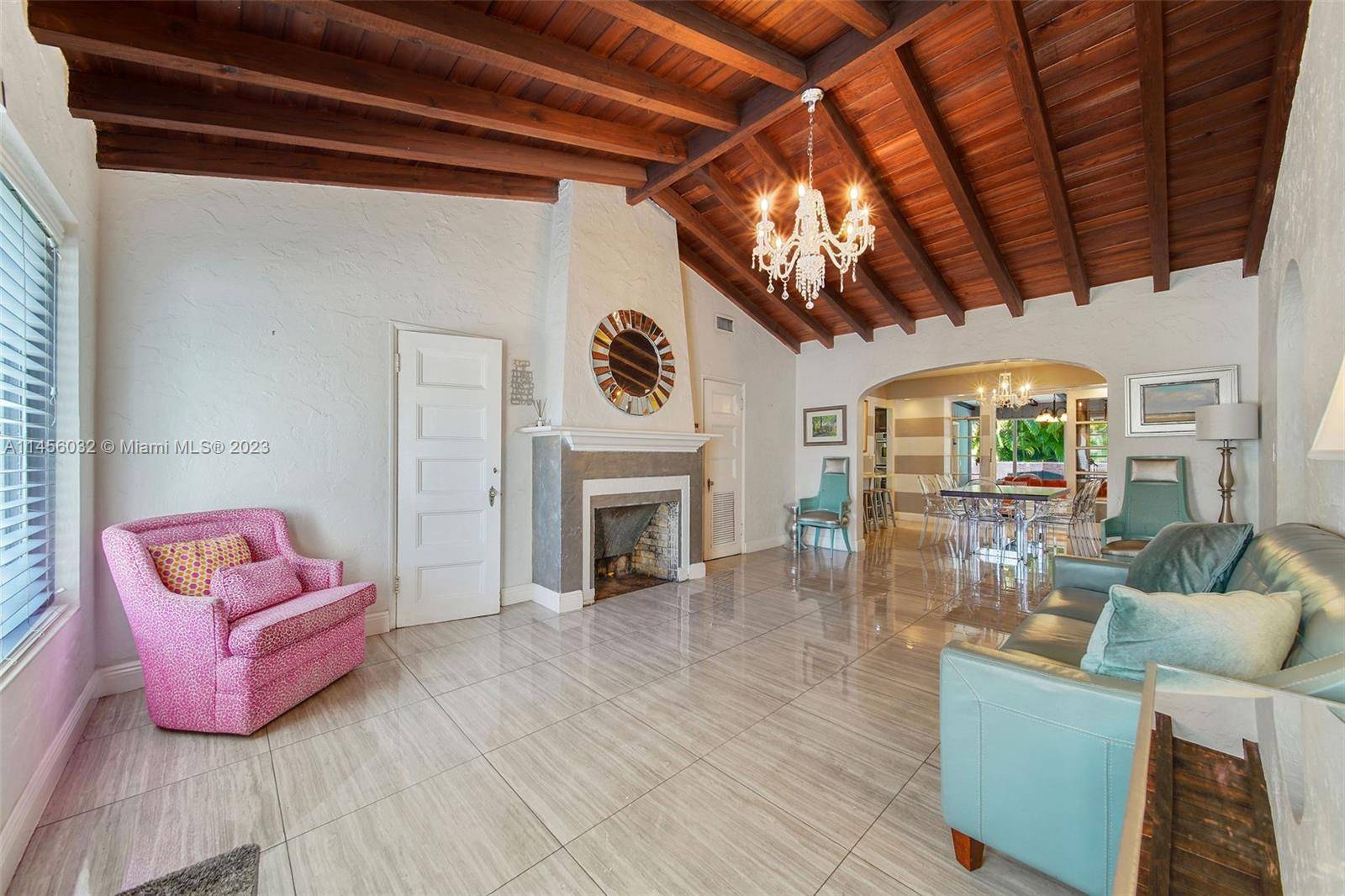 ntroducing 427 W 43rd St, this renovated home will greet you with high wooden beam ceilings with a cozy fireplace as you enter.
