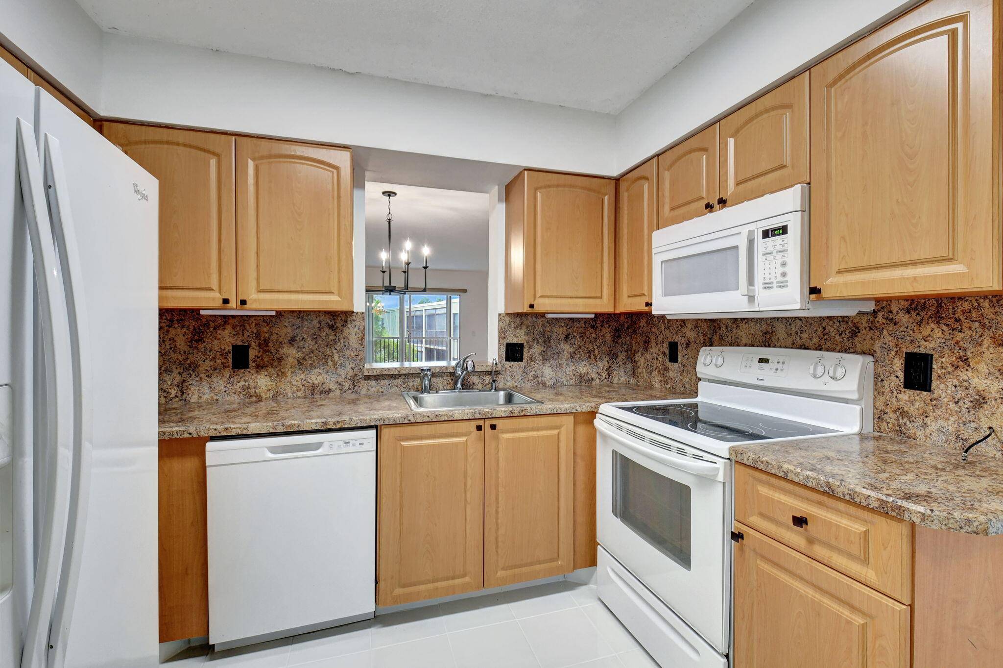 Move in Ready ! Discover this beautifully maintained corner penthouse unit, featuring a stunning kitchen with granite countertops, large pantry, and meticulous ceramic tile floors.