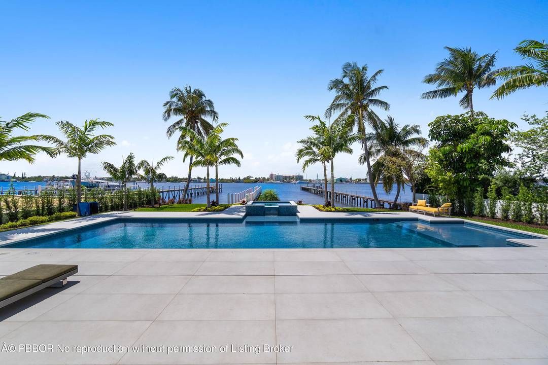 Experience refined, effortless living in this gorgeous waterfront estate nestled in the private enclave of Hypoluxo Island.