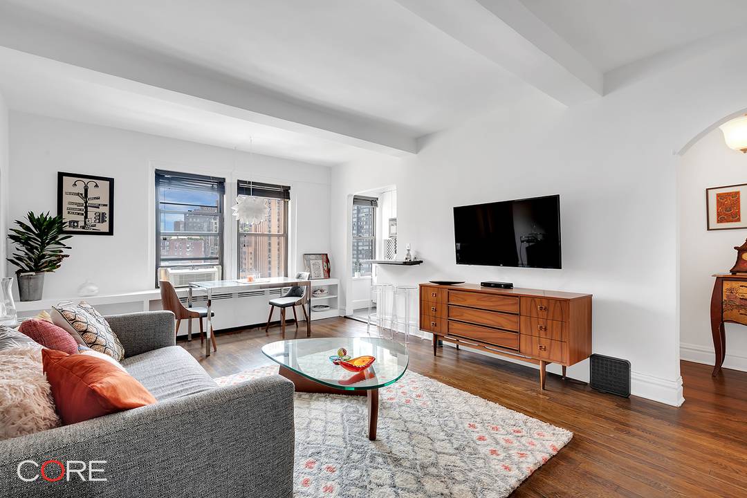 Residence 12G is a meticulously renovated one bedroom home that blends pre war charm with modern convenience, featuring high beamed ceilings, arched entryways, and large windows that bathe the space ...