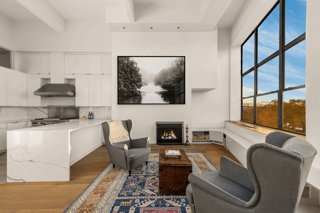 Rarely available duplex loft with 15 ft ceilings and massive windows showcasing spectacular Hudson River views in the heart of the West Village.