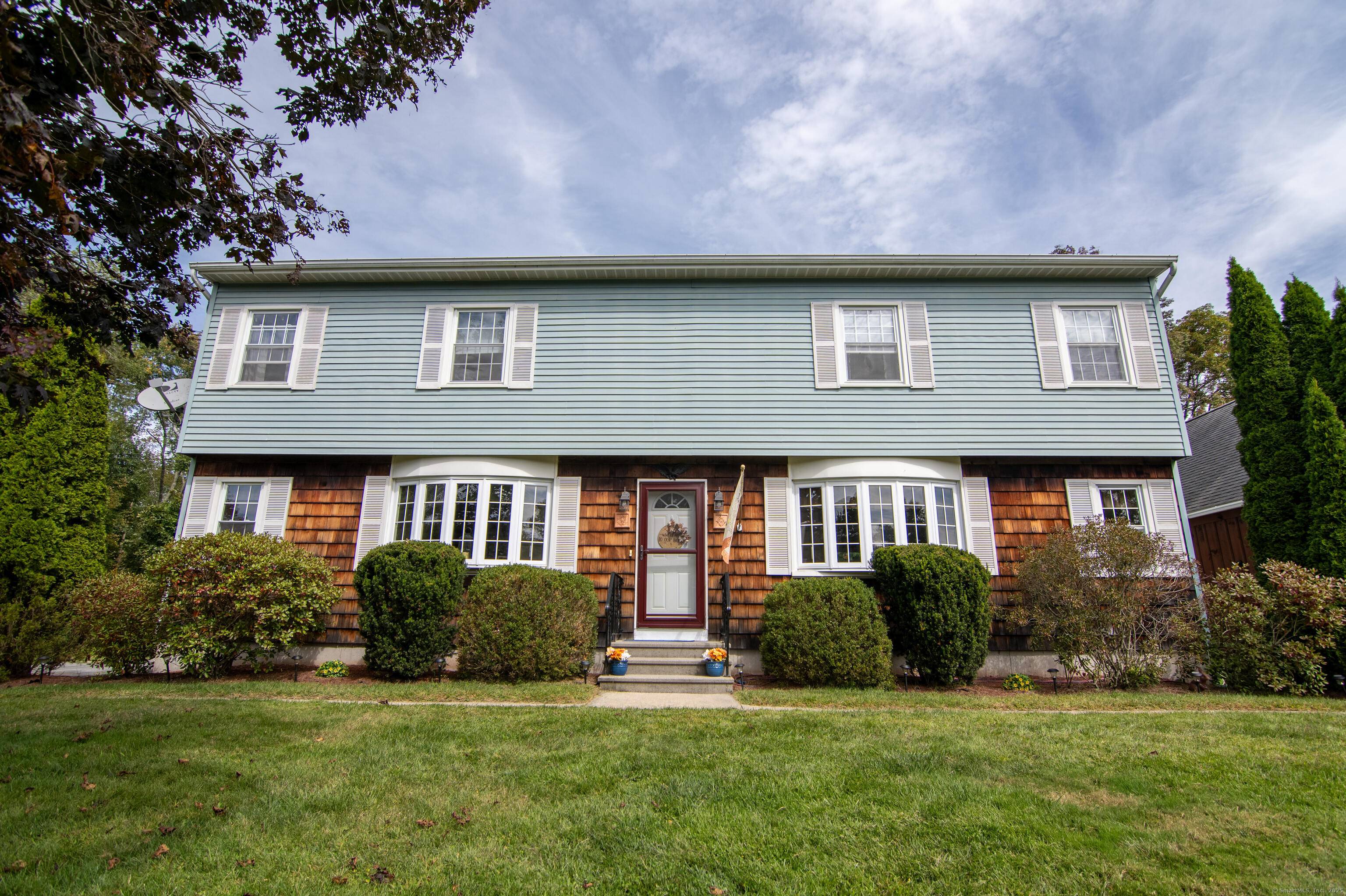 Beautifully maintained Colonial home sits far off road on a pristine lot.