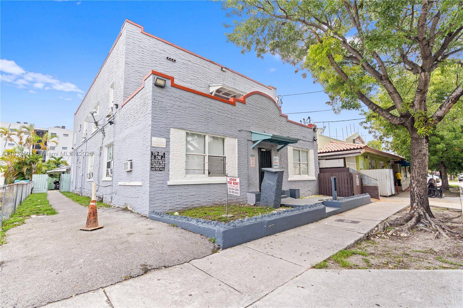 Little Havana 2 story multi family building with free standing duplex in the rear.