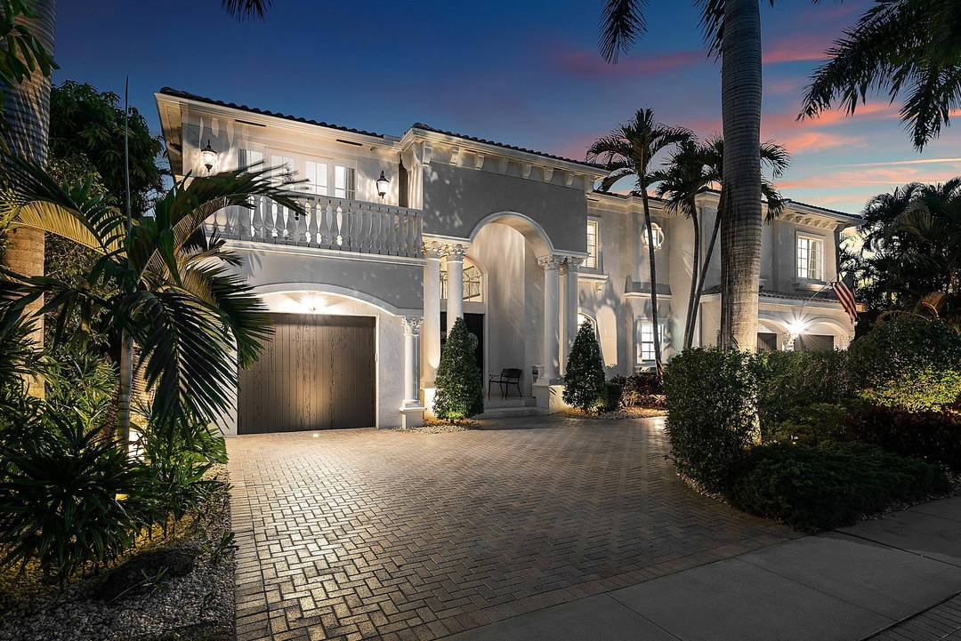 A striking grand double door entry introduces this Mediterranean waterfront home in Boca Harbour, ideally located in Boca Raton.
