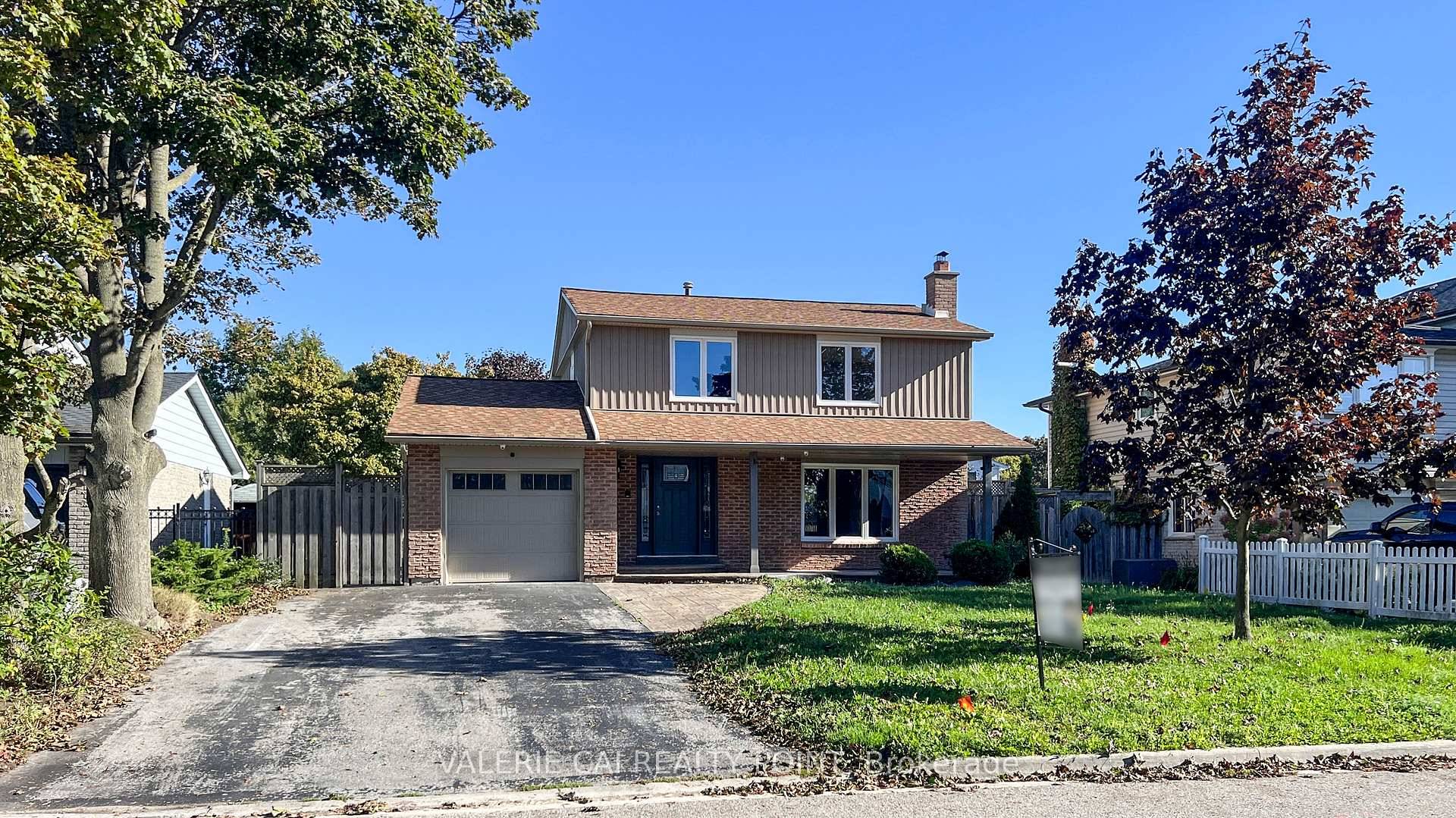 Impressive curb appeal with beautifully landscaped grounds, including a welcoming front porch.