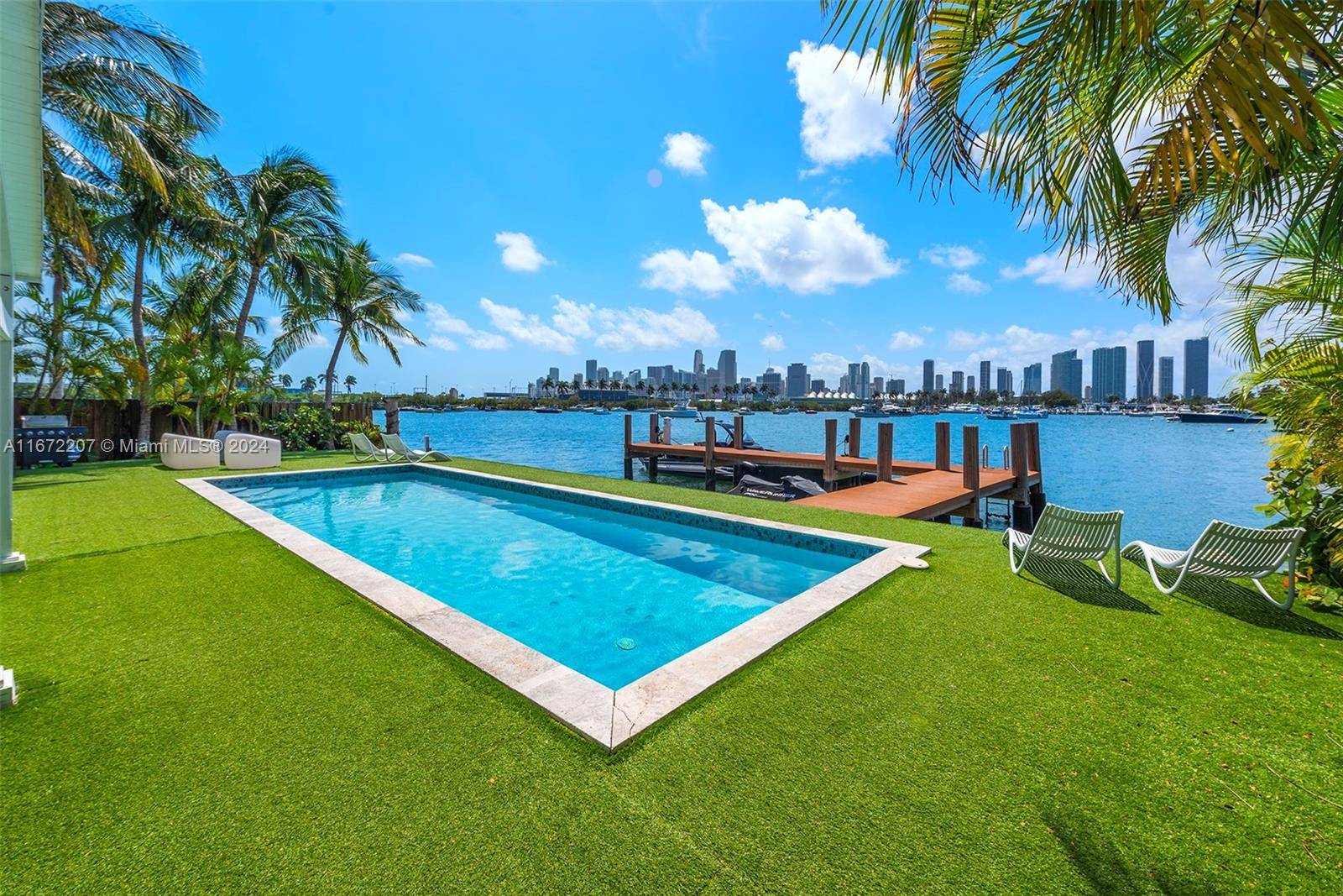 Experience the chance to build your dream home or update the current 2 story waterfront residence on Palm Island s sought after western tip, showcasing panoramic views of the Miami ...