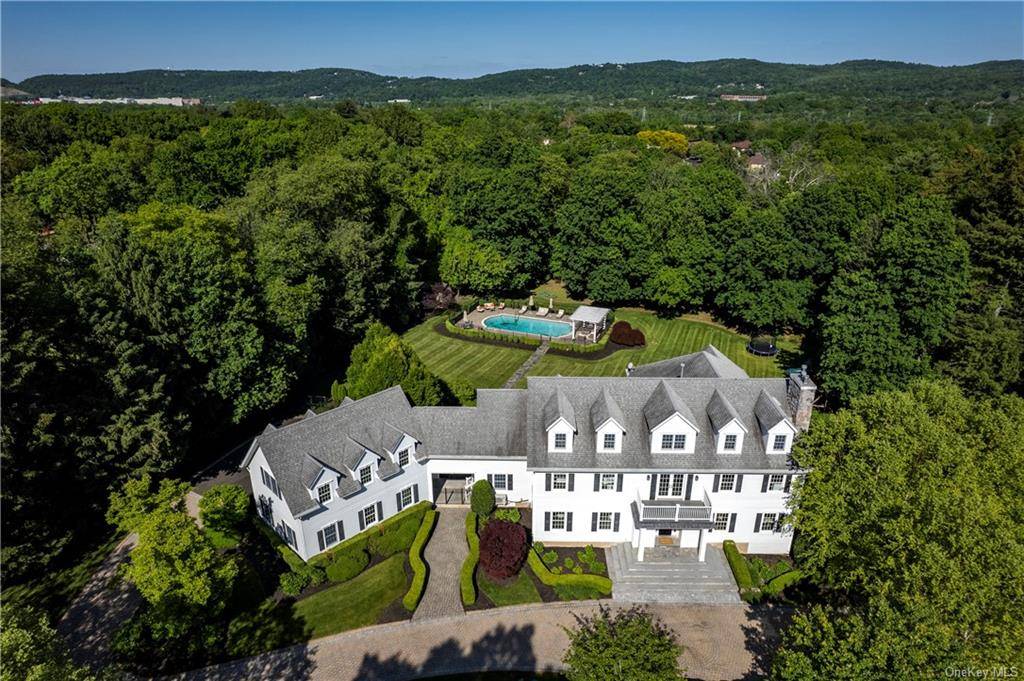 Located only 30 minutes from NYC and sited on a lush and private 1.