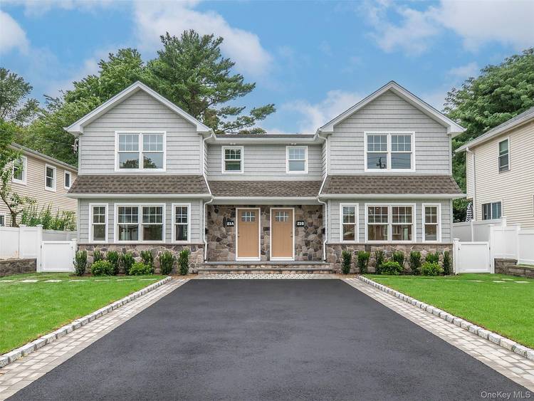 Luxury New Construction Duplex featuring spacious living dining open floor plan, modern kitchen and powder room on the main level.