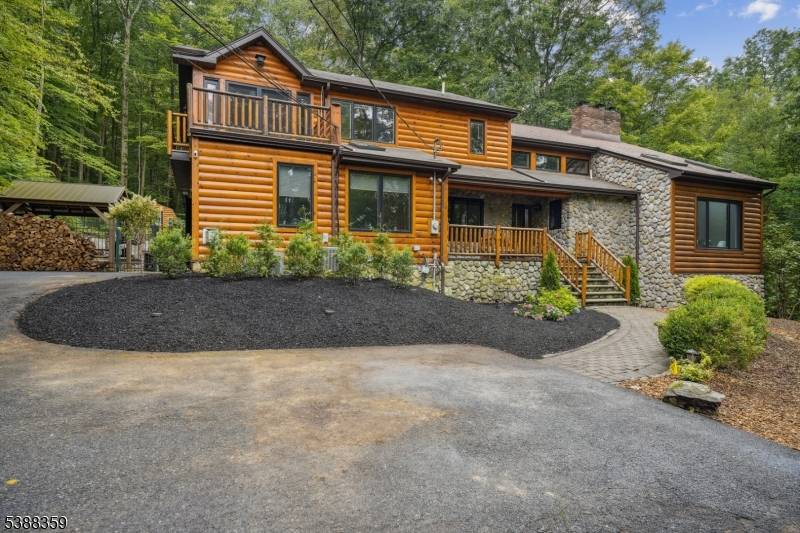 Welcome to this stunning Custom Home featuring a log exterior, situated 5 minutes from vibrant downtown Morristown.
