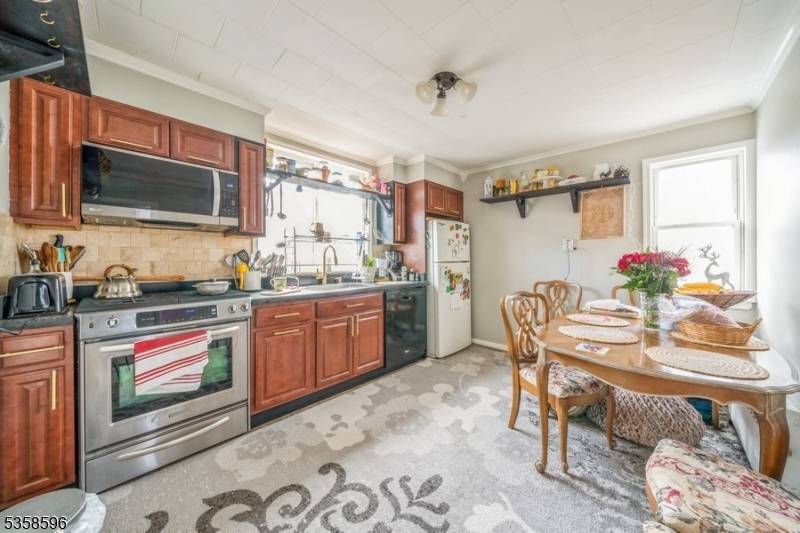 Welcome to this charming and well maintained three family home located in the heart of Bayonne, NJ.
