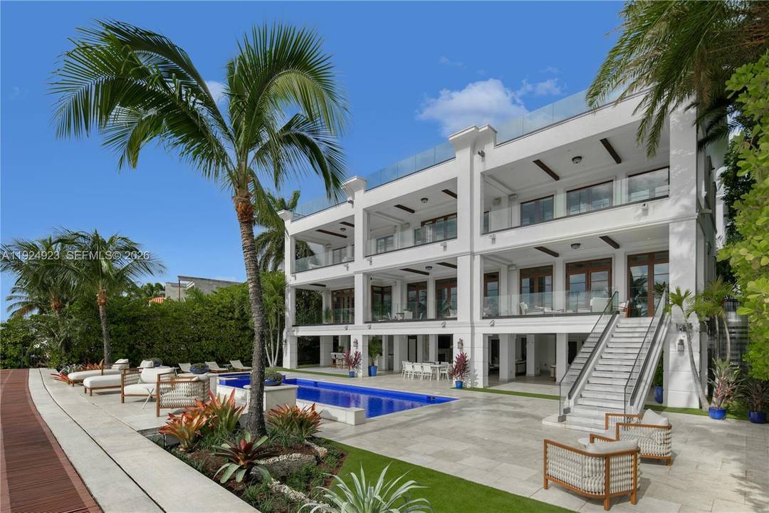 Experience luxury living in this exquisite 3 story waterfront estate, offering 100 of prime water frontage on the prestigious, guard gated Palm Island.