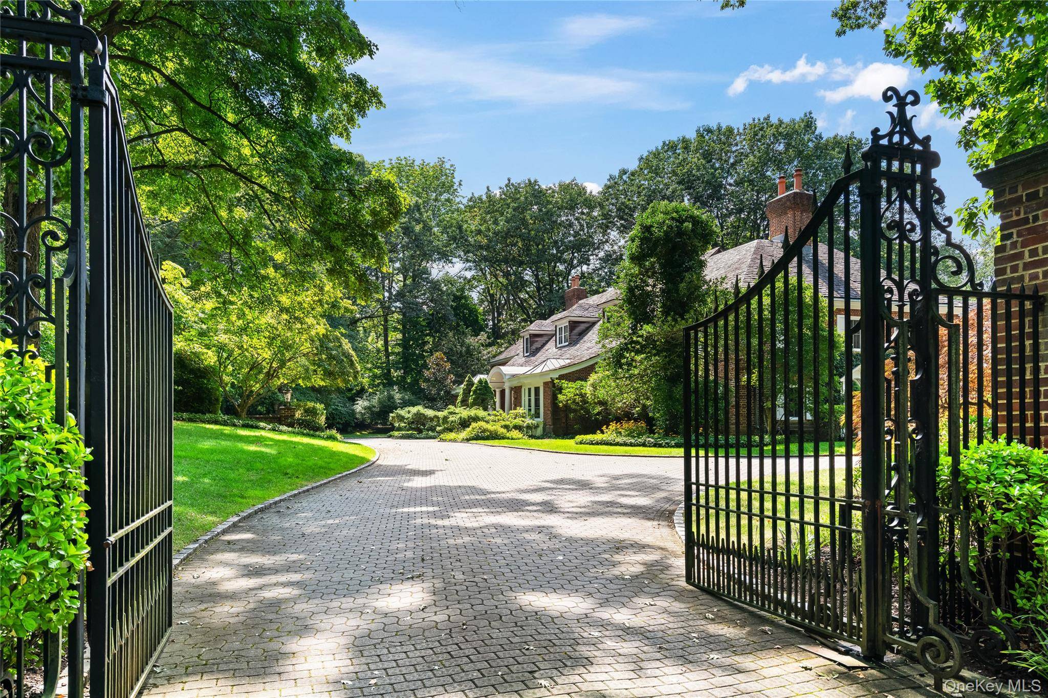 ROSLYN HARBOR ; Timeless Brick Manor Behind iron gates and a sweeping paver driveway, this 1926 Great Gatsby era estate, sitting on 2.