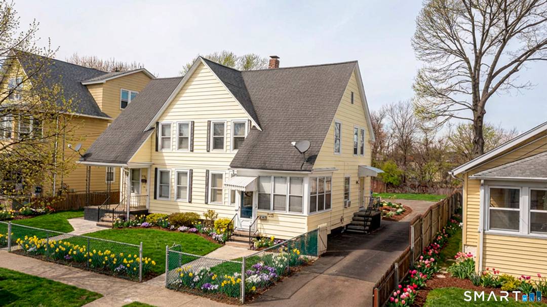 Beautiful two family side by side duplex features granite countertops, hardwood floors, and SS appliances.