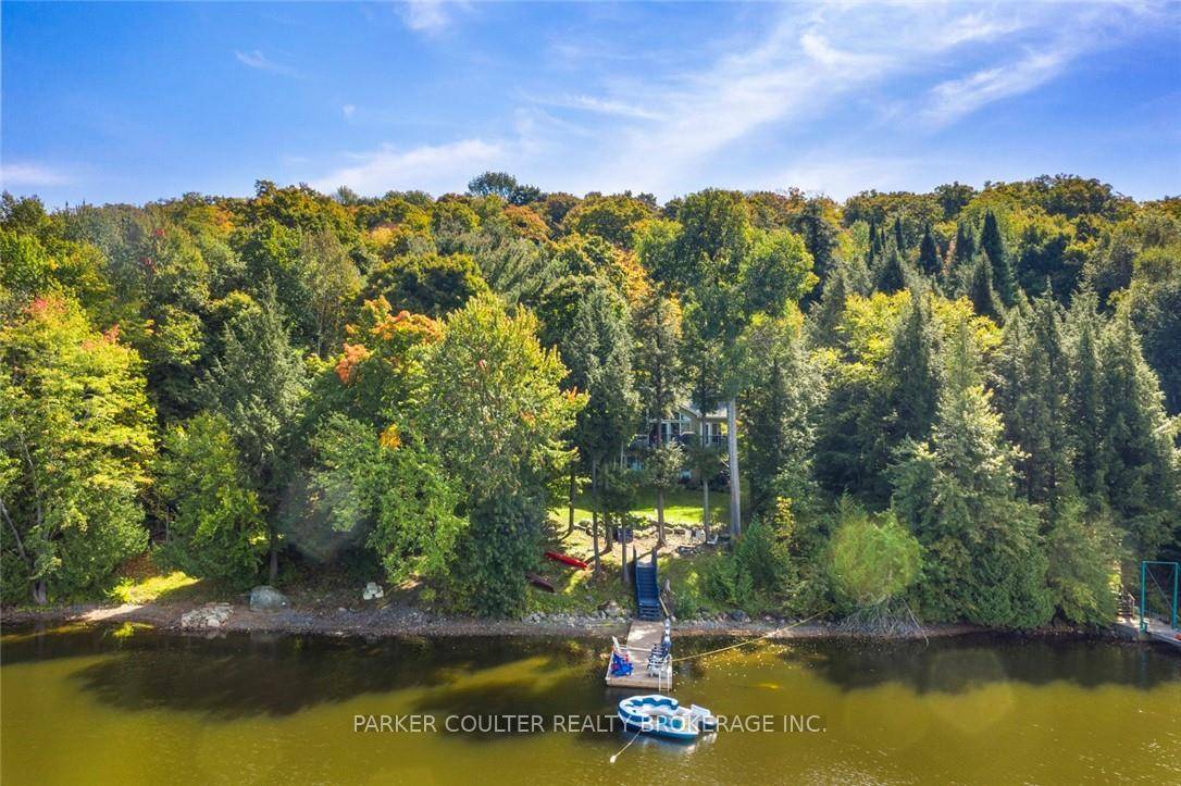 Discover the perfect getaway at this charming 2 storey home nestled on the shores of Three Mile Lake.