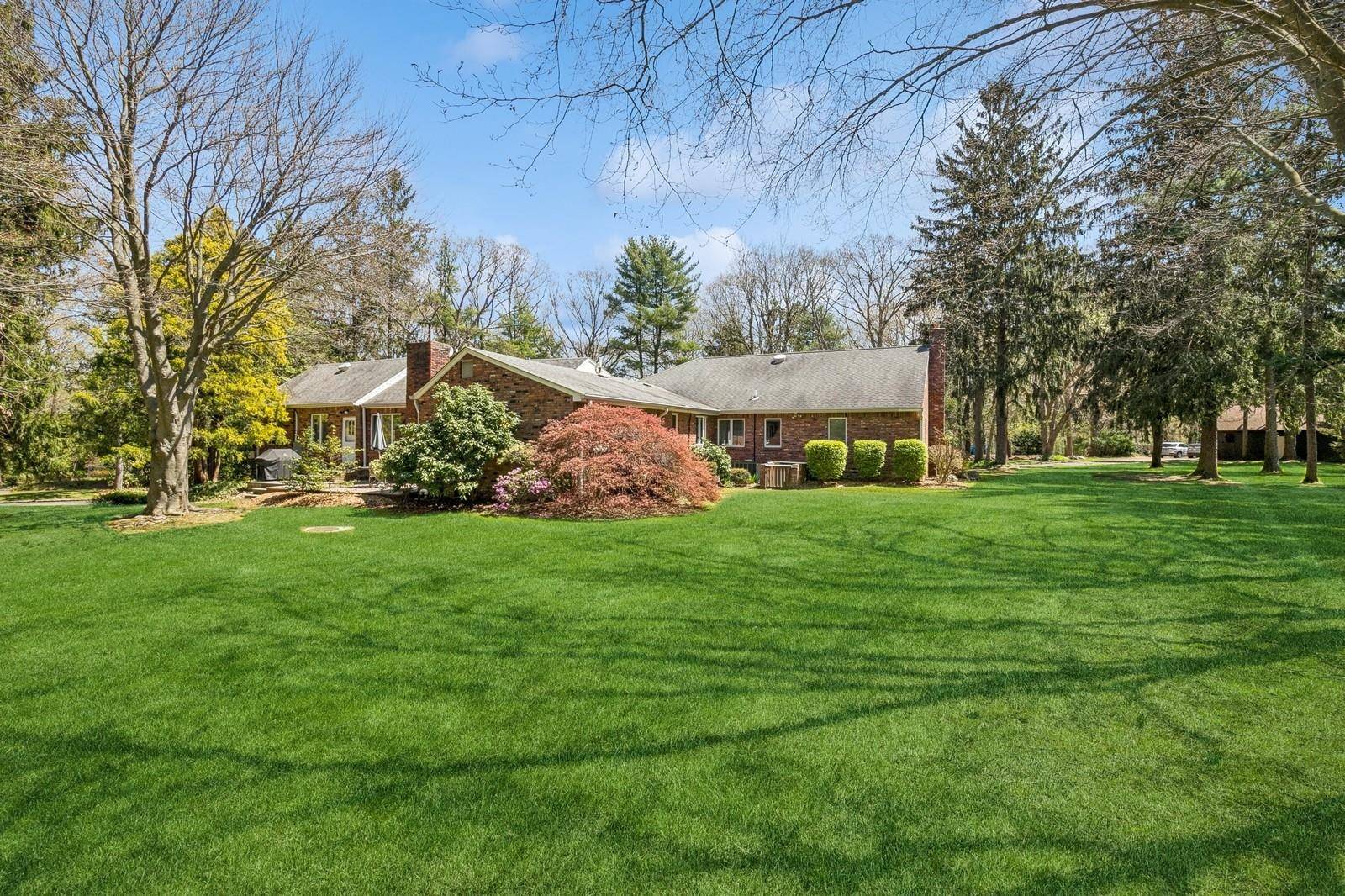 This lovely, expanded Ranch is perfectly situated on a 2 acre manicured lot on a quiet, tree lined street.