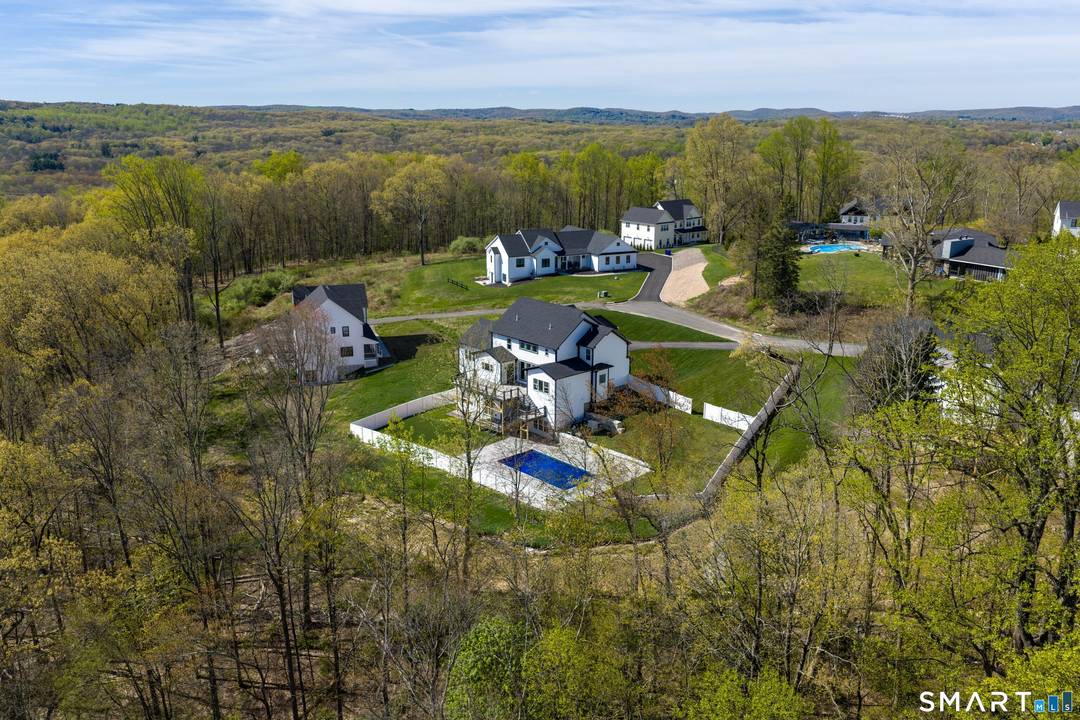 A bold expression of modern design, this NEW CONSTRUCTION Modern Farmhouse is set on 1.