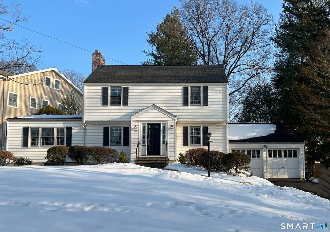 Fall in love with this classic 1930s Colonial, beautifully perched on a hill with wonderful curb appeal on a corner lot.