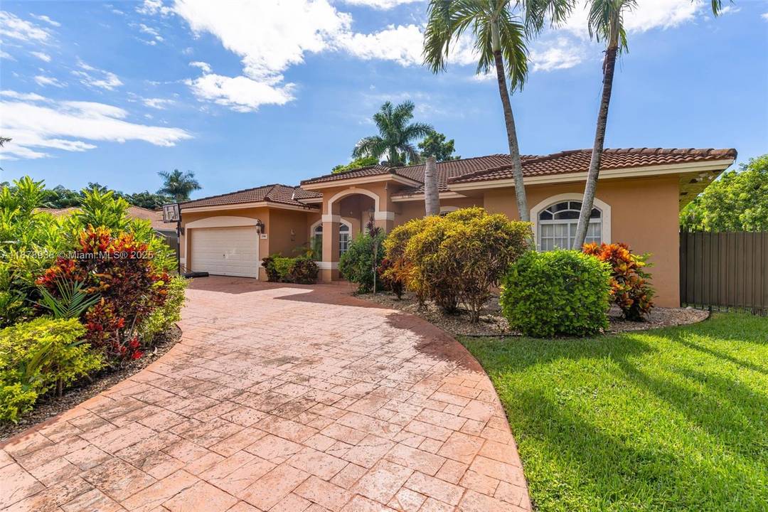 Nestled in the highly sought after Redlands area, this stunning residence sits on an expansive lot surrounded by lush greenery and tropical landscaping.