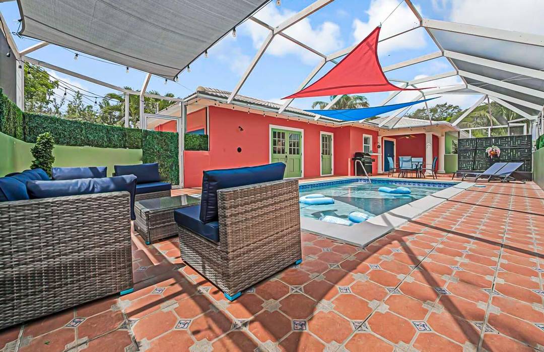 Located in the heart of Lake Worth Beach, this vibrant 3BR 2BA home features a screened in pool with colorful sail shades, a fun garage game room, and lush fenced ...