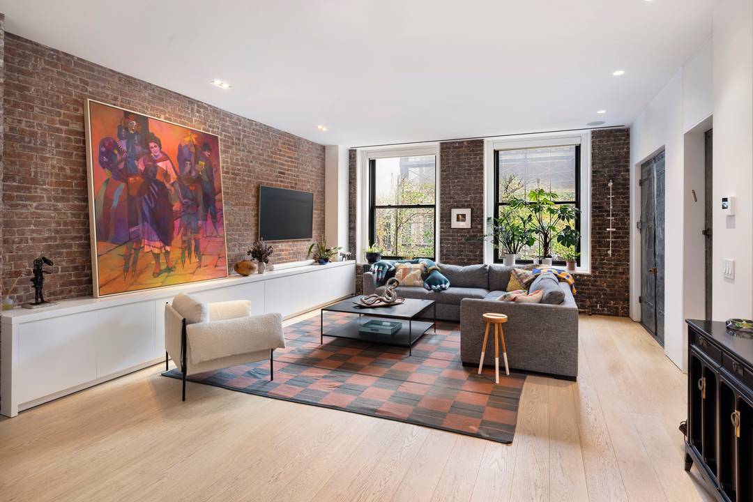 Residence 3W at 28 East 4th Street is a beautifully designed two bedroom loft that seamlessly blends downtown character with modern luxury.