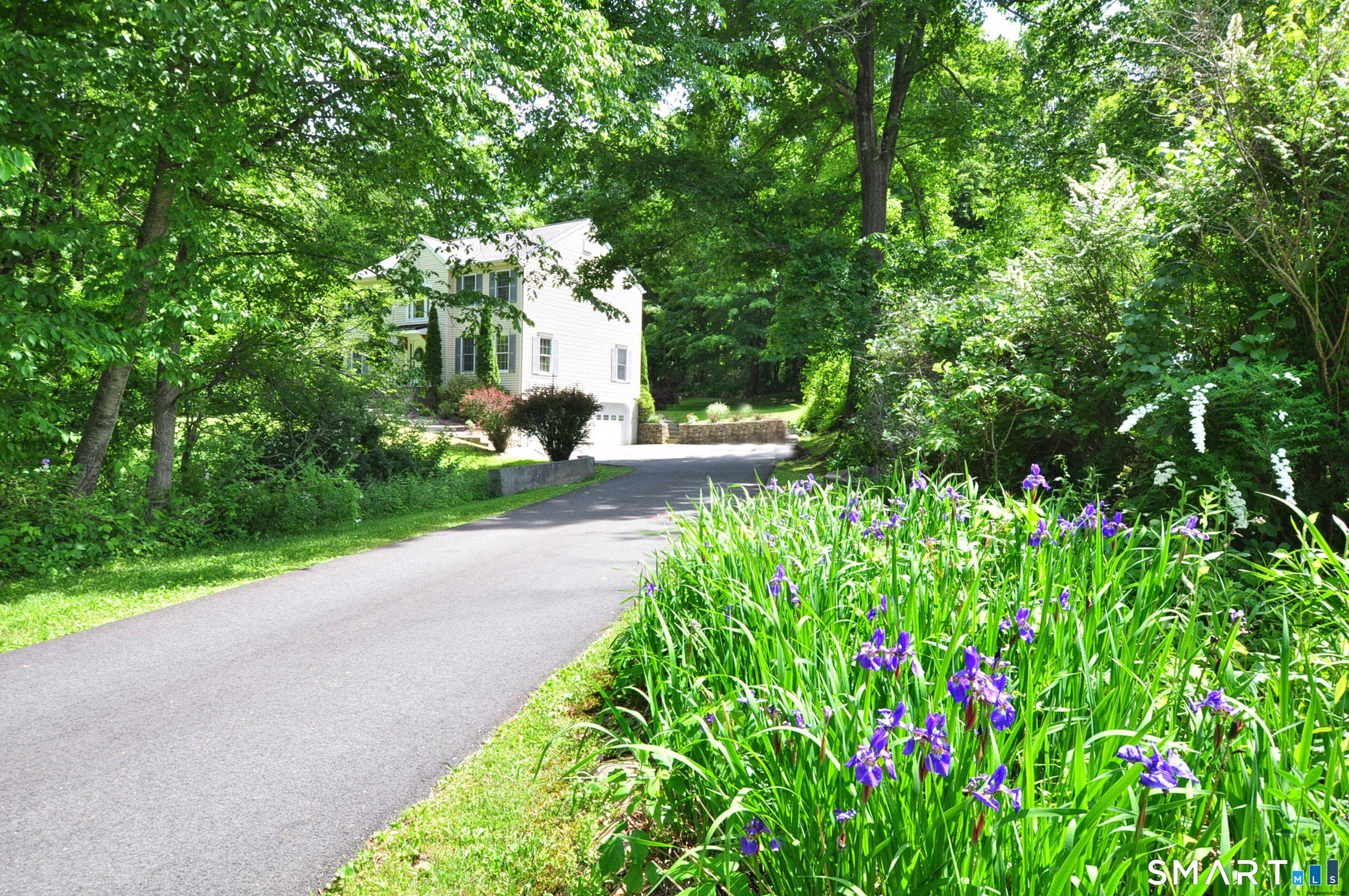 There's a joyful sparkle shine throughout this distinctive Colonial home a rare hidden treasure in Southern New Milford's most desired Meadowbrook.
