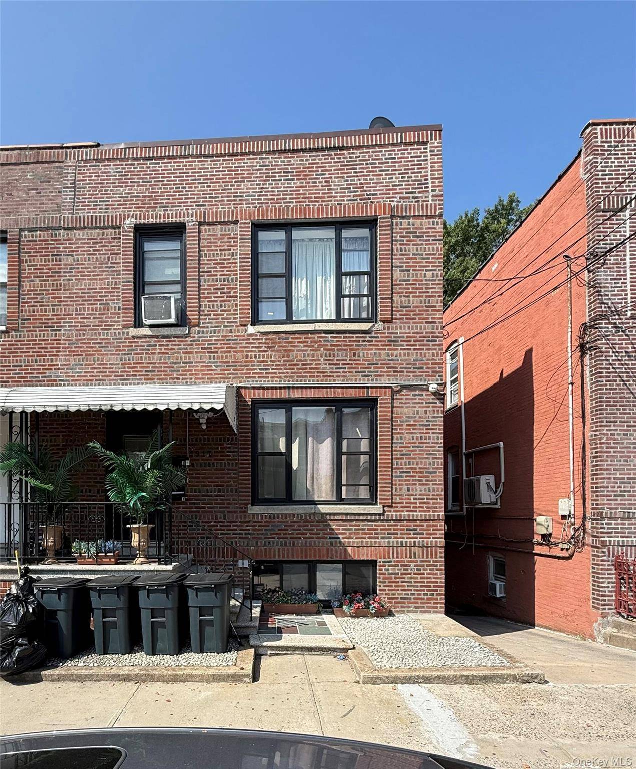Extra large brick legal three family located in the heart of Morris Park !