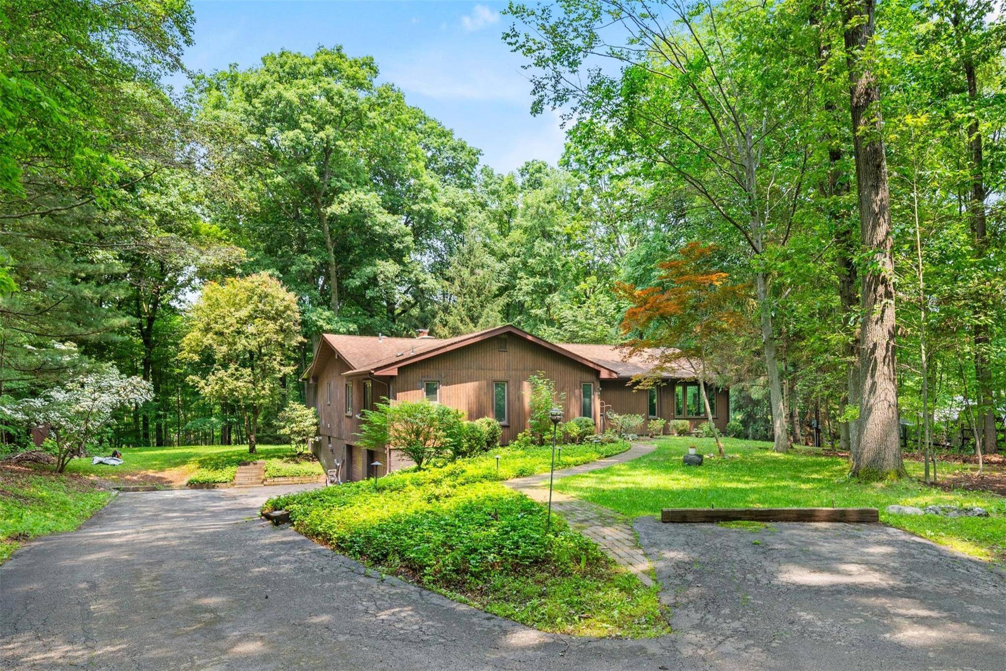 Spacious and serene, this single story ranch is set on a quiet, wooded 1.