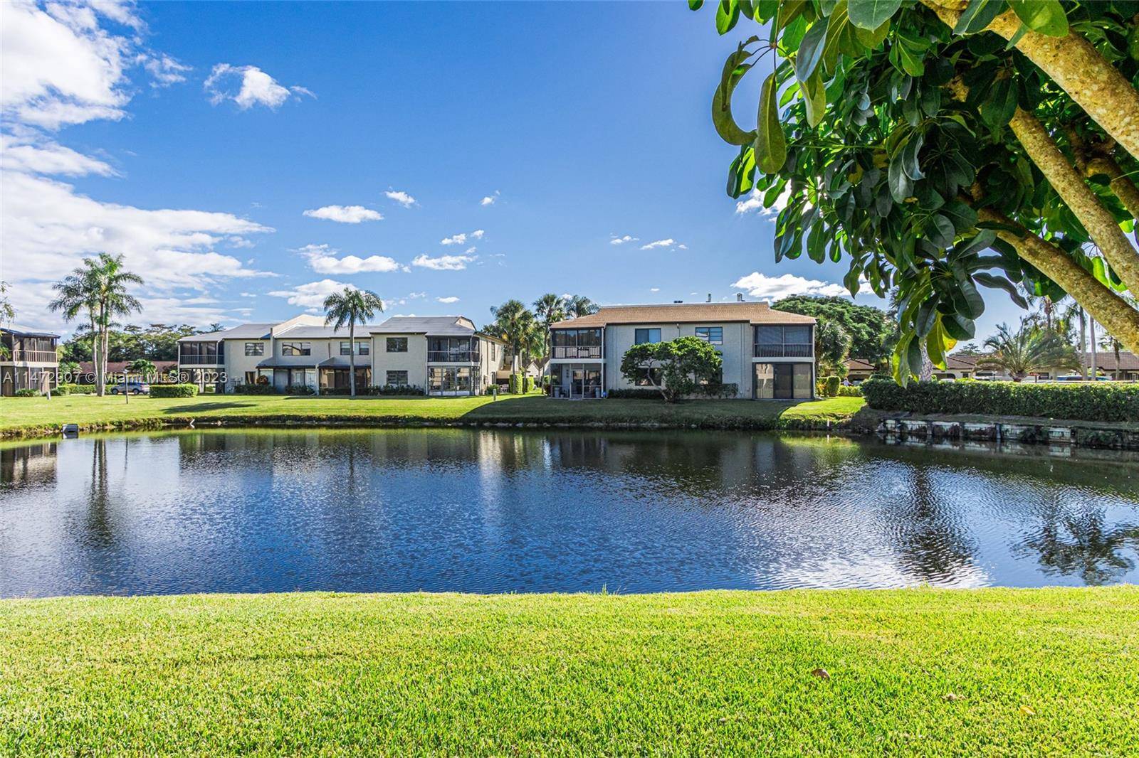 WONDERFUL CORNER UNIT 2 2 WITH AMAZING LAKE VIEW, GLASS ENCLOSED PATIO FOR EXTRA DEN ROOM, WHITE TILE FLOORS.